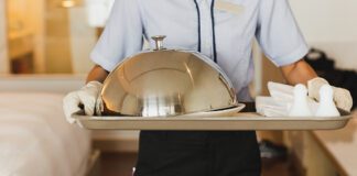 Hospitality worker dealing room service to Hotel Room